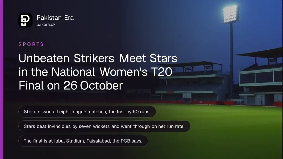 An empty cricket stadium under floodlights at dusk