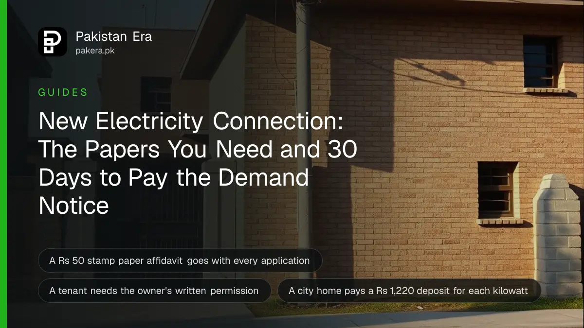 A newly built brick house on a quiet street with a concrete electricity pole and overhead service wire at its gate