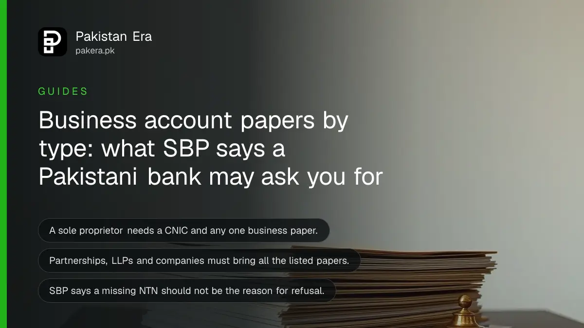 Cream folders and a brass paperweight on a dark wooden table, for a guide on business bank account documents in Pakistan