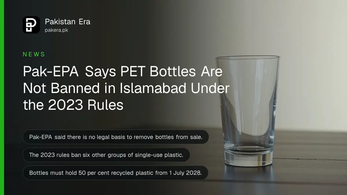 A clear empty drinking glass on a dark wooden table, for Pak-EPA's statement that PET bottles are not banned in Islamabad