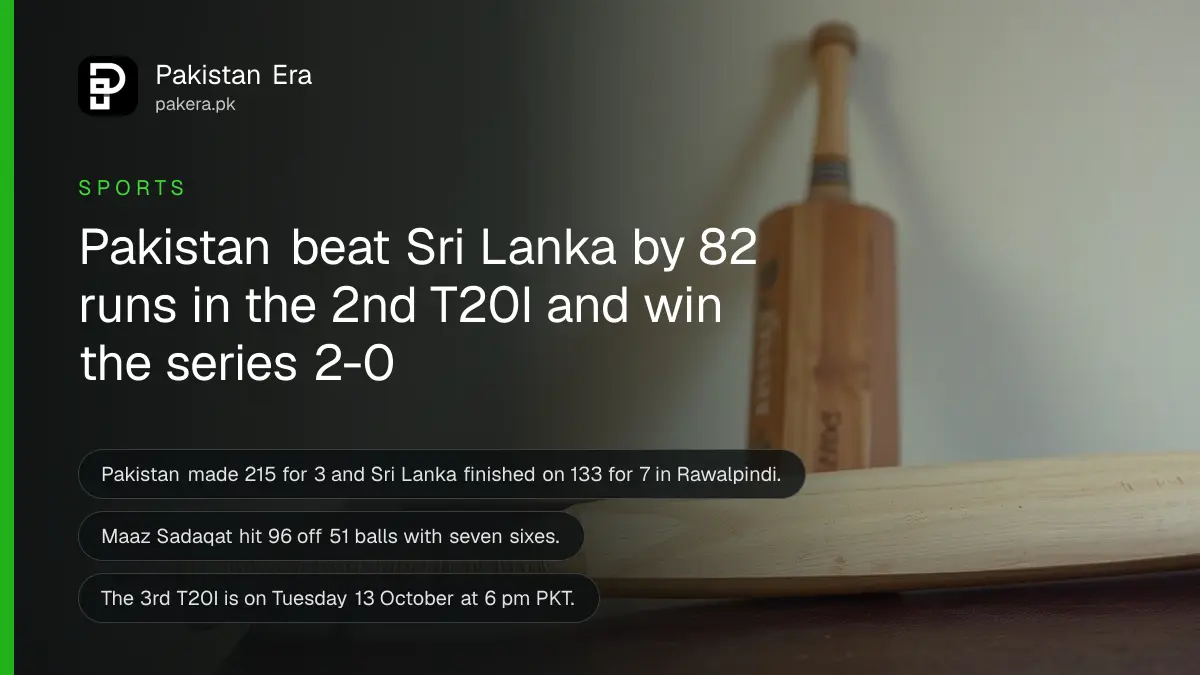 A plain wooden cricket bat resting on a dark wooden table against a cream wall