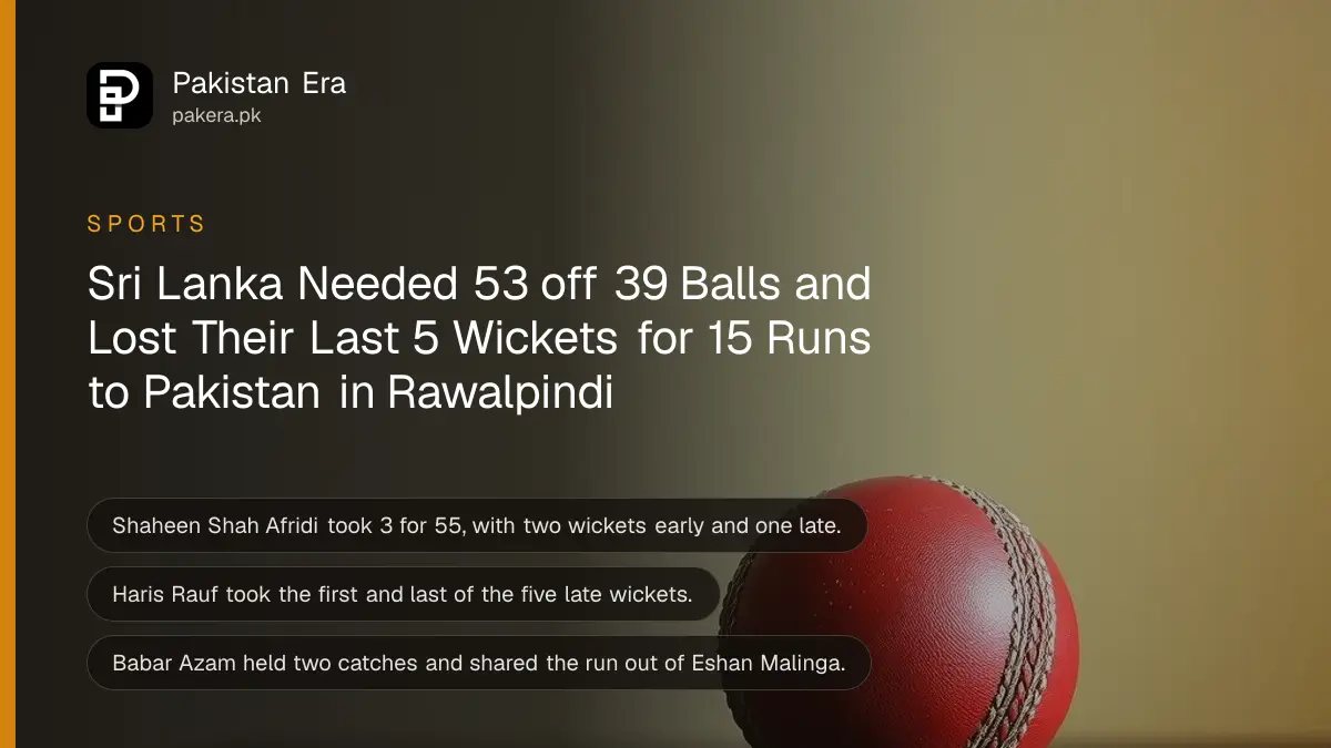 A red leather cricket ball on a dark wooden table against a plain cream wall