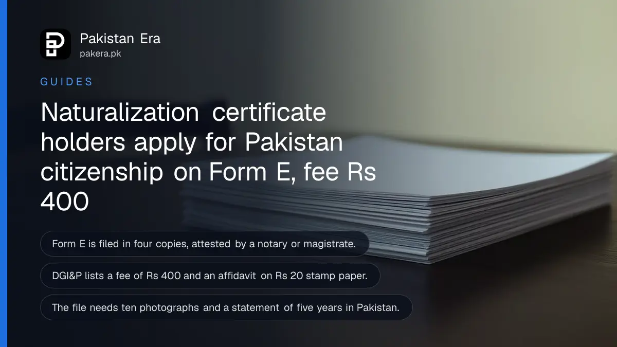 A stack of blank paper on a dark wooden table, for a guide to Form E citizenship in Pakistan