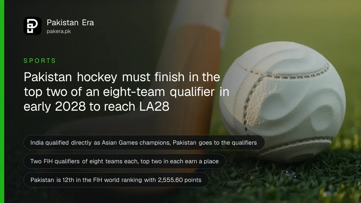 A white field hockey ball beside a hockey stick on green turf in morning light