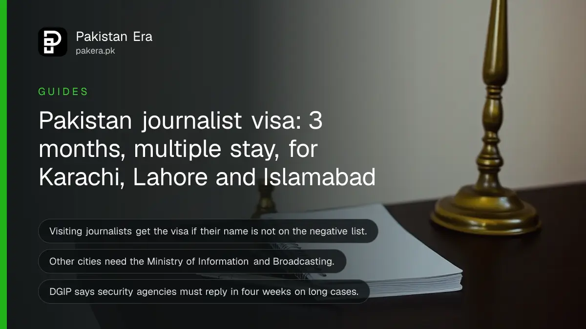 A plain notebook, silver pen and brass lamp on a dark wooden table, for a guide on the Pakistan journalist visa
