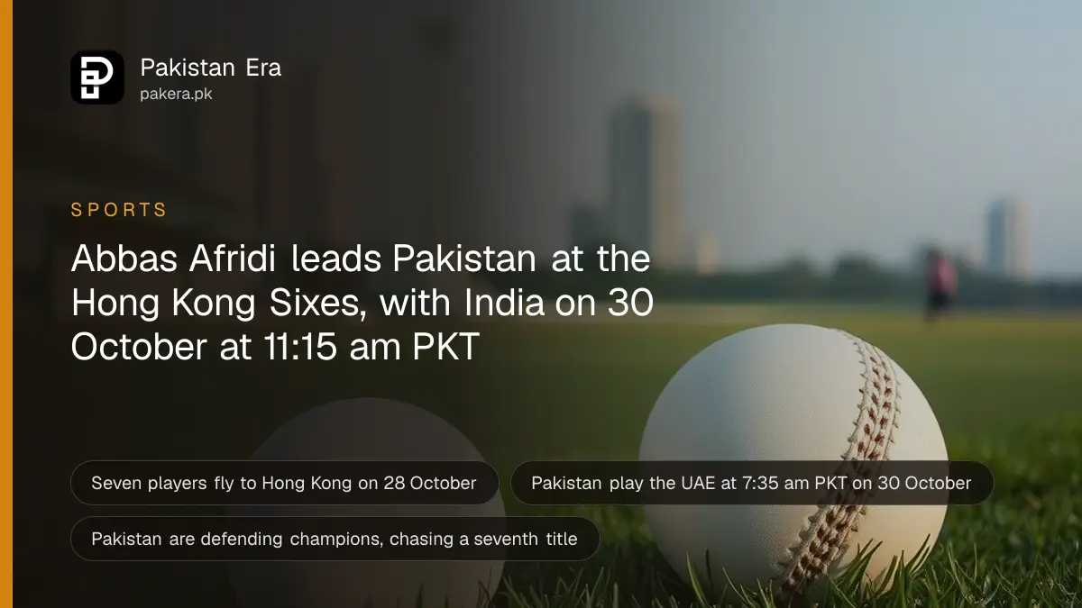 Two white cricket balls on the grass with city towers behind