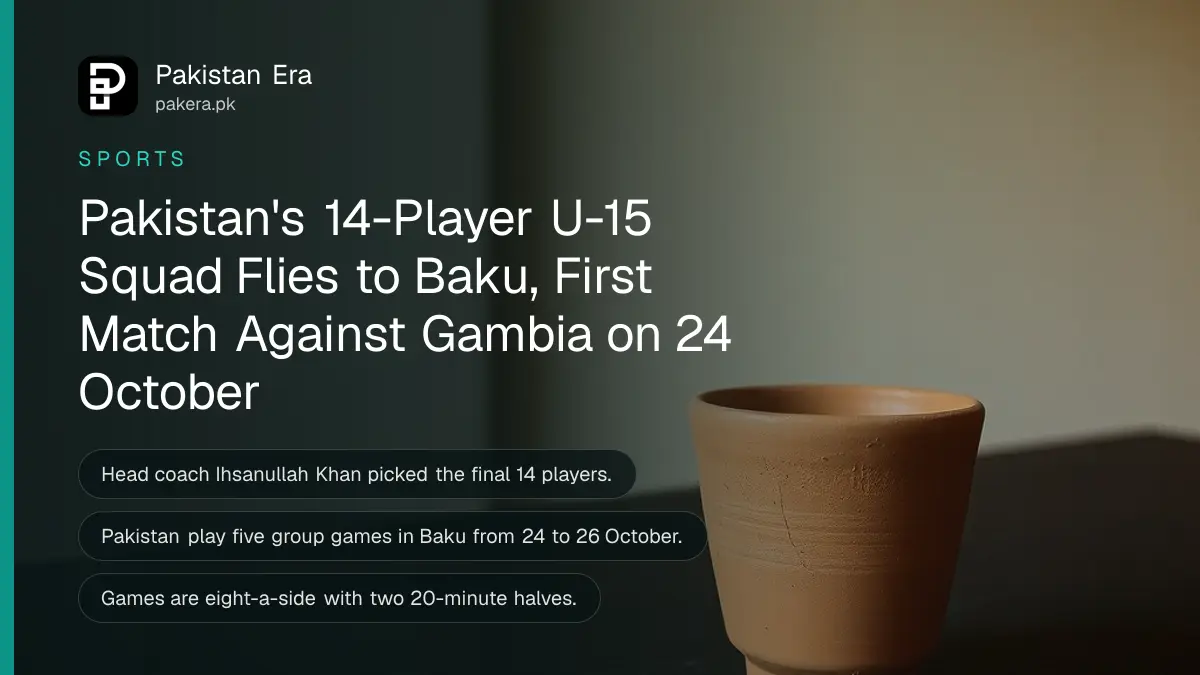 A plain terracotta clay cup on a dark wooden table against a plain cream wall