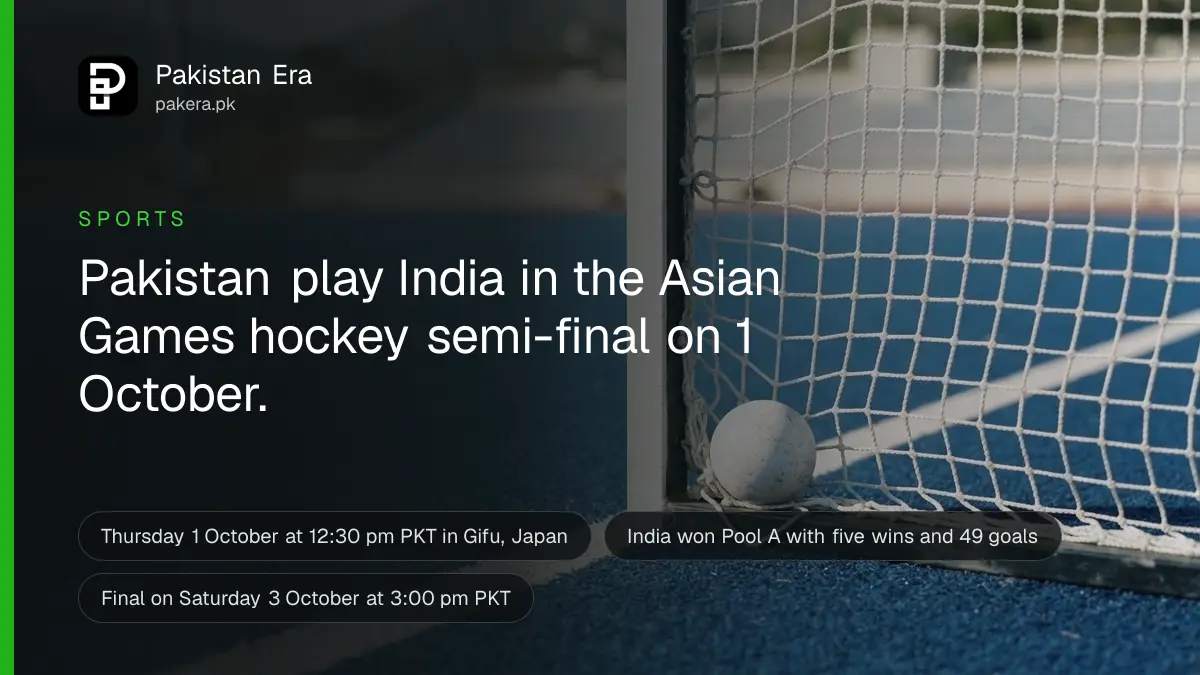 A white hockey ball resting in the corner of a goal net on blue artificial turf