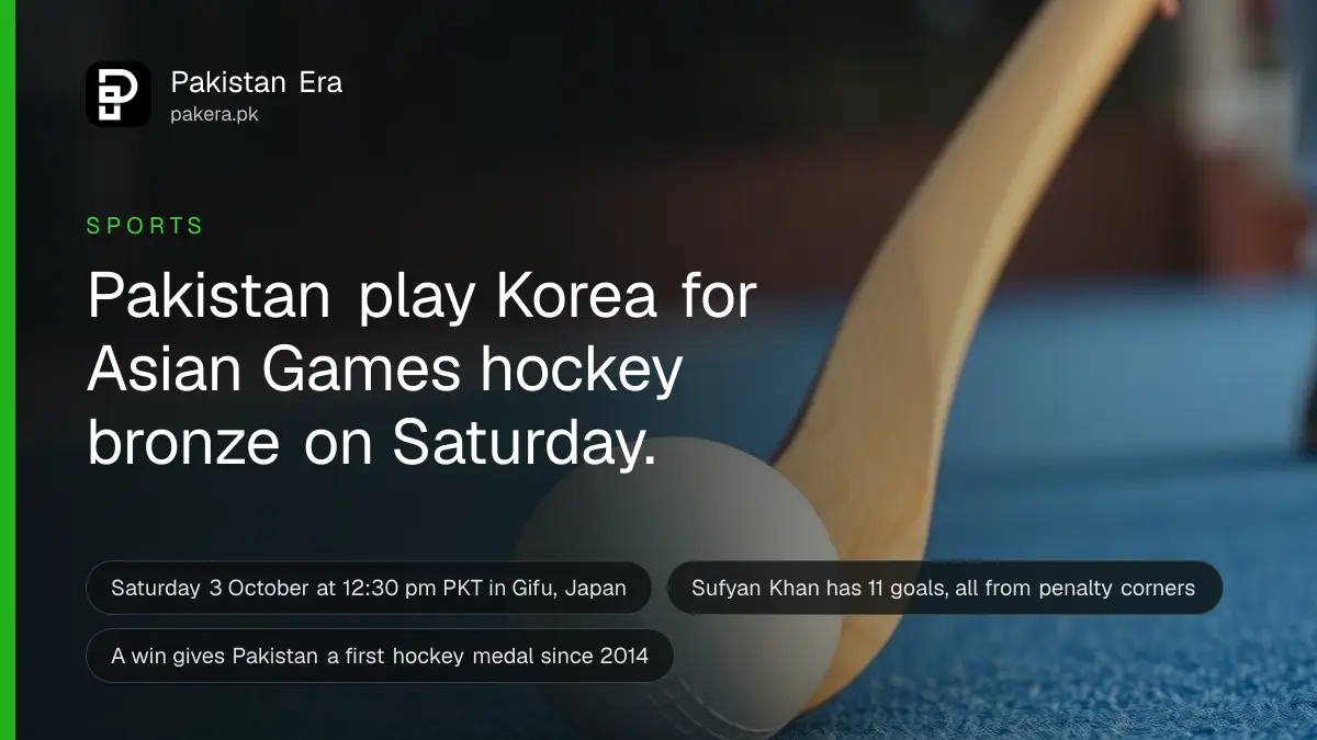 A white hockey ball and a hockey stick on blue turf under floodlights