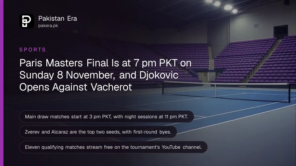 An empty indoor tennis arena with a dark blue hard court under bright lights and rows of empty seats