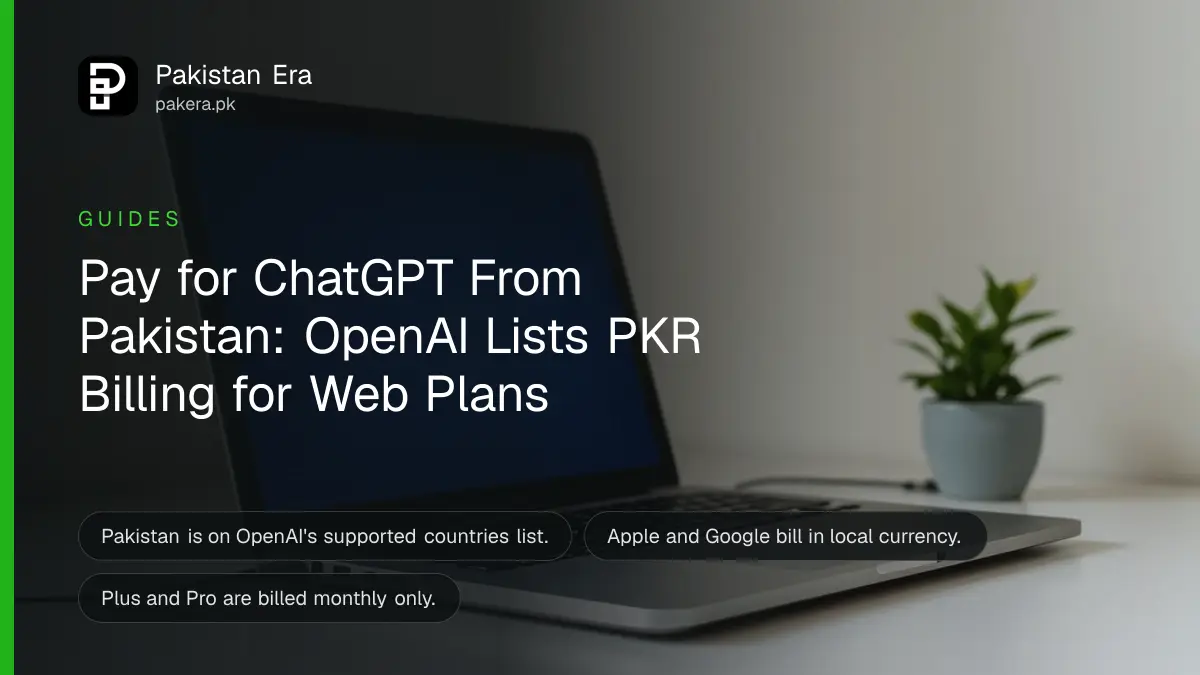 An open laptop with a glowing screen on a tidy desk beside a plant