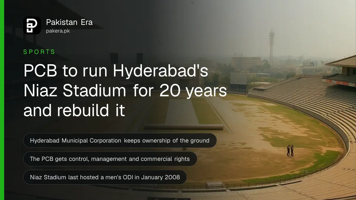 Rows of empty faded concrete stands around a dry, patchy cricket outfield under a hazy afternoon sky in Hyderabad