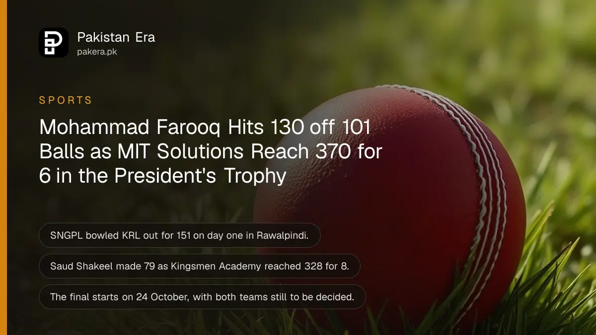 A plain red leather cricket ball resting on short green grass