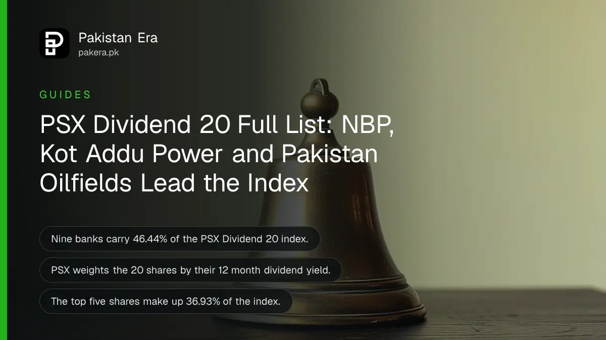 A brass bell on a dark wooden table against a plain cream wall in soft daylight