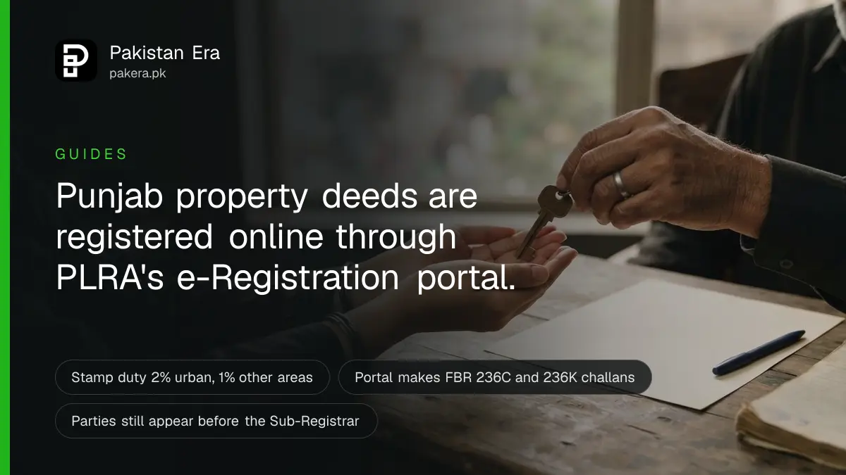 Two pairs of hands passing a house key across an office desk beside a blank deed in Lahore