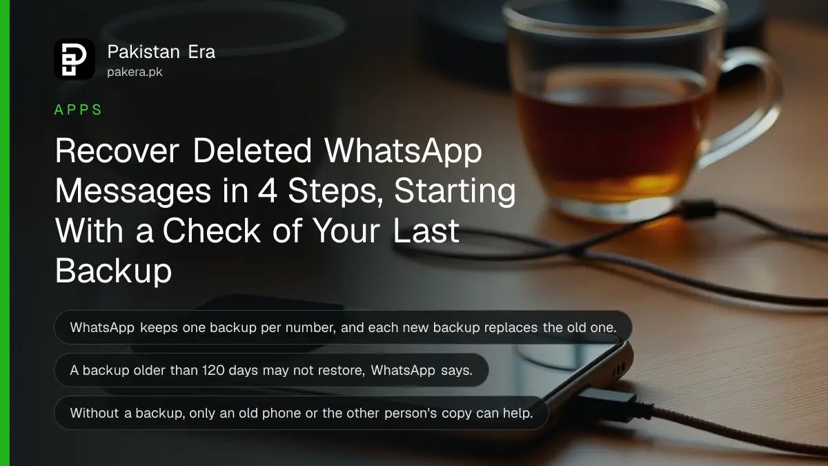 A smartphone lying face up on a wooden desk with its screen dark beside a cup of tea in evening light