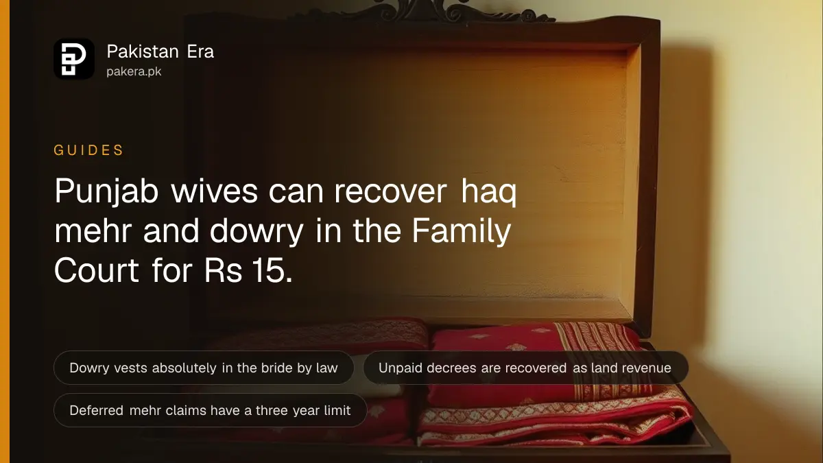 A carved wooden dowry chest with folded embroidered fabrics and gold bangles in soft light