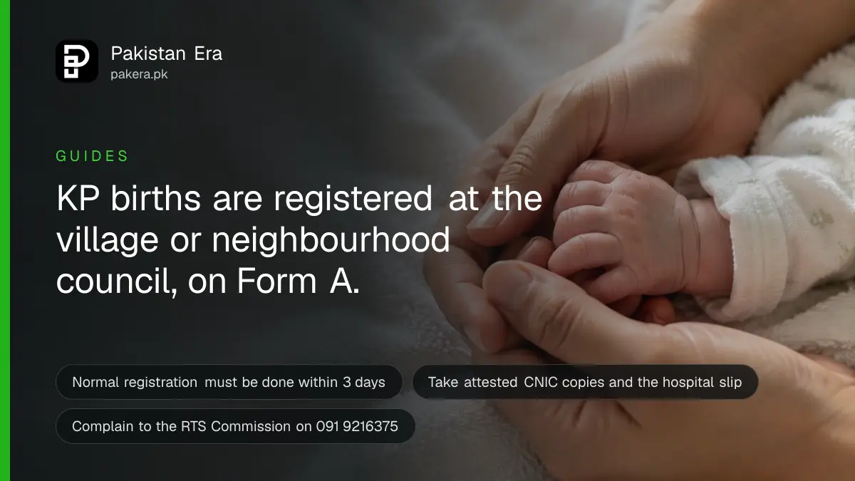 A newborn's small hand resting on a soft knitted blanket beside a parent's finger