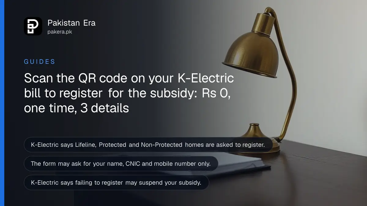 A small brass desk lamp and a closed notebook on a dark wooden table, for a guide to K-Electric subsidy registration