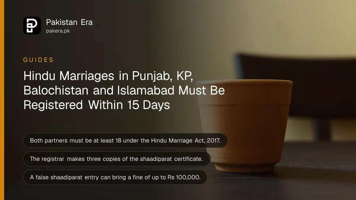 A clay cup on a dark wooden table against a plain cream wall in soft daylight