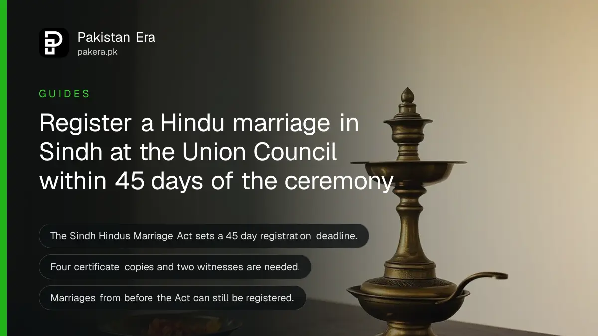 Two brass oil lamps and marigold petals on a wooden table, for a guide to Hindu marriage registration in Sindh