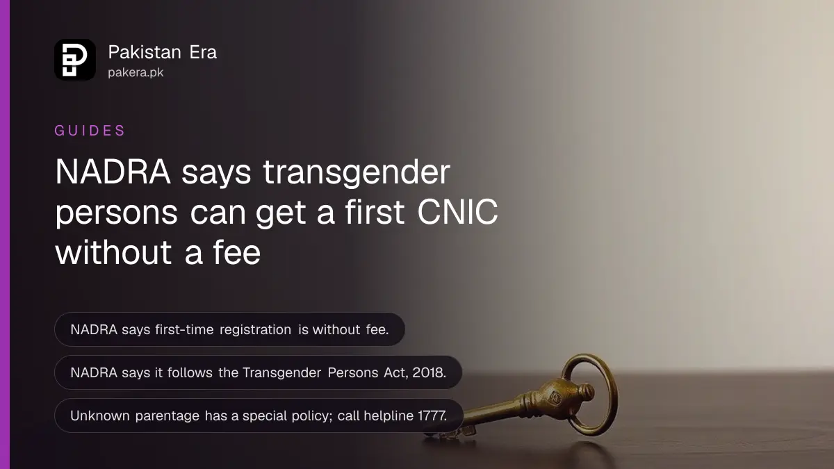 A brass key on a dark wooden table, for a guide to transgender CNIC registration at NADRA