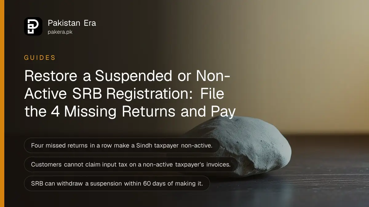 A single smooth grey river stone on a dark wooden table against a plain cream wall