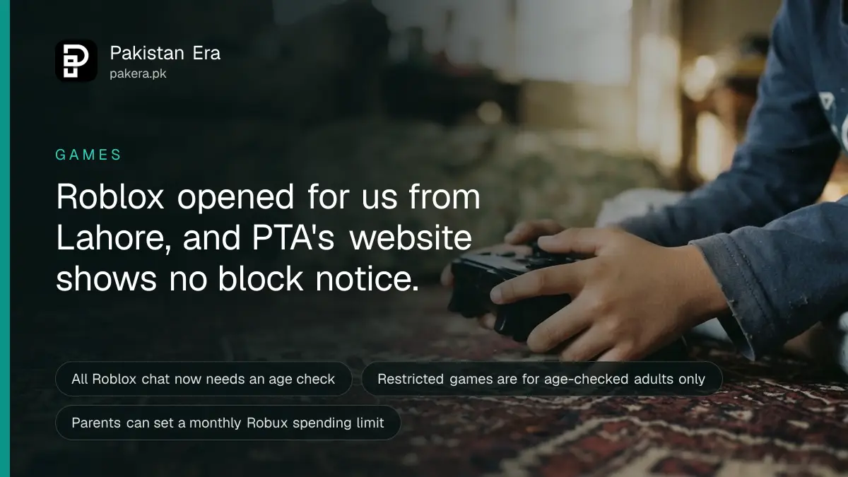 A child's hands holding a game controller while sitting on a patterned carpet in Lahore