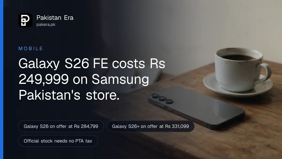 A slim dark smartphone lying face down on a wooden desk beside a cup of coffee