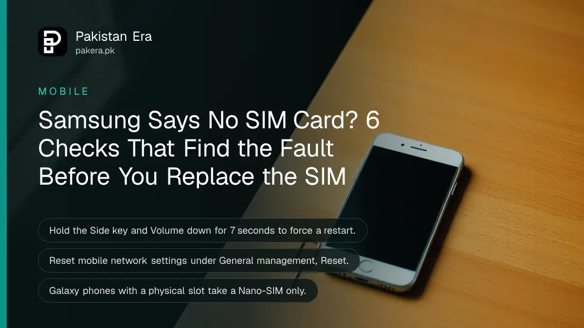 A smartphone lying face up on a wooden desk with its screen dark, a small SIM tray and ejector pin beside it