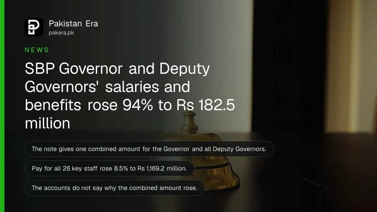 A plain brass desk bell on a dark wooden table against a plain cream wall, for a story on central bank leadership pay