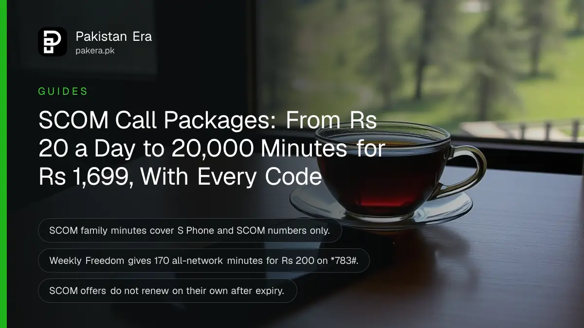 A smartphone and a cup of tea on a wooden table beside a window looking over a green Kashmir valley