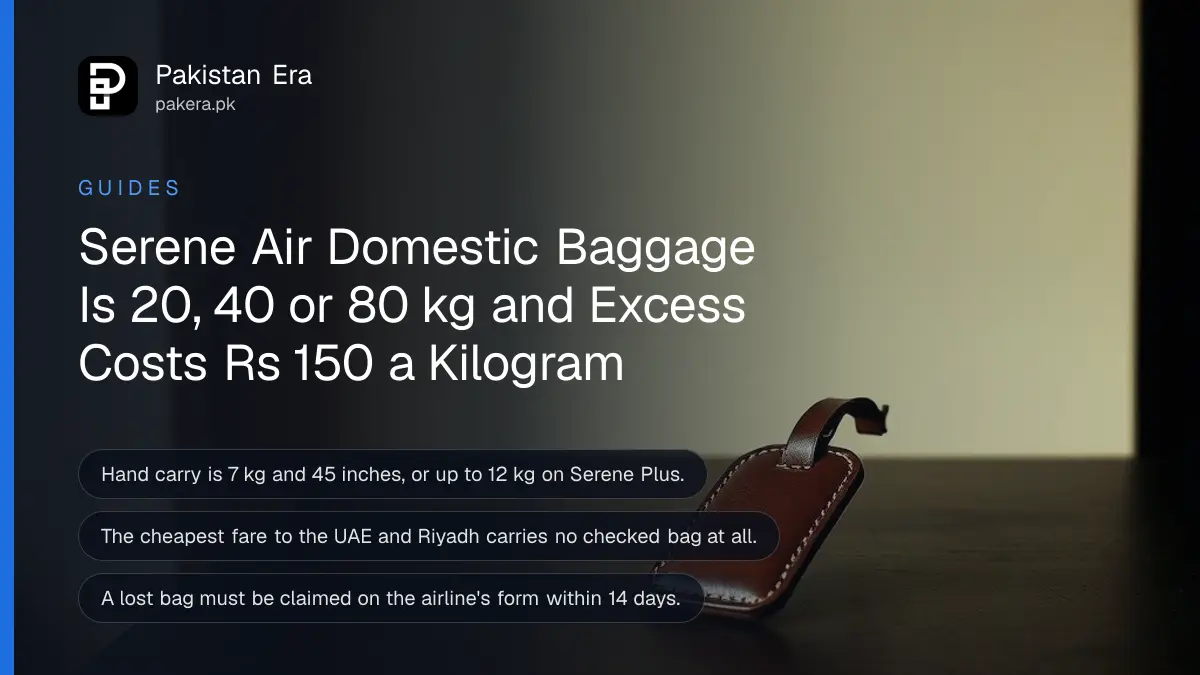 A small leather luggage tag resting on a dark wooden table against a plain cream wall in soft daylight