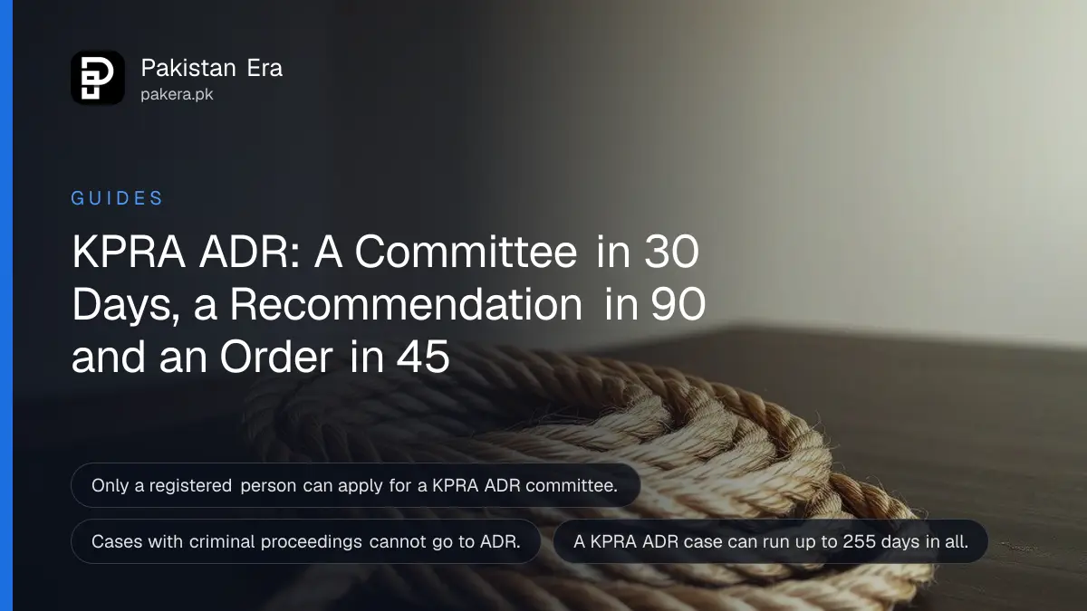 A neat coil of thick natural rope on a dark wooden table against a plain cream wall