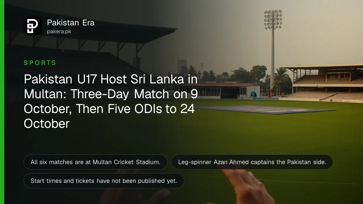 An empty cricket ground in Multan at dusk with a covered pitch, a pavilion and floodlight towers in the distance