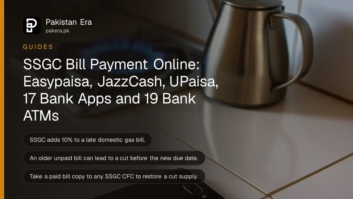 A blue gas flame burning on a kitchen stove beside a smartphone lying face up on the counter
