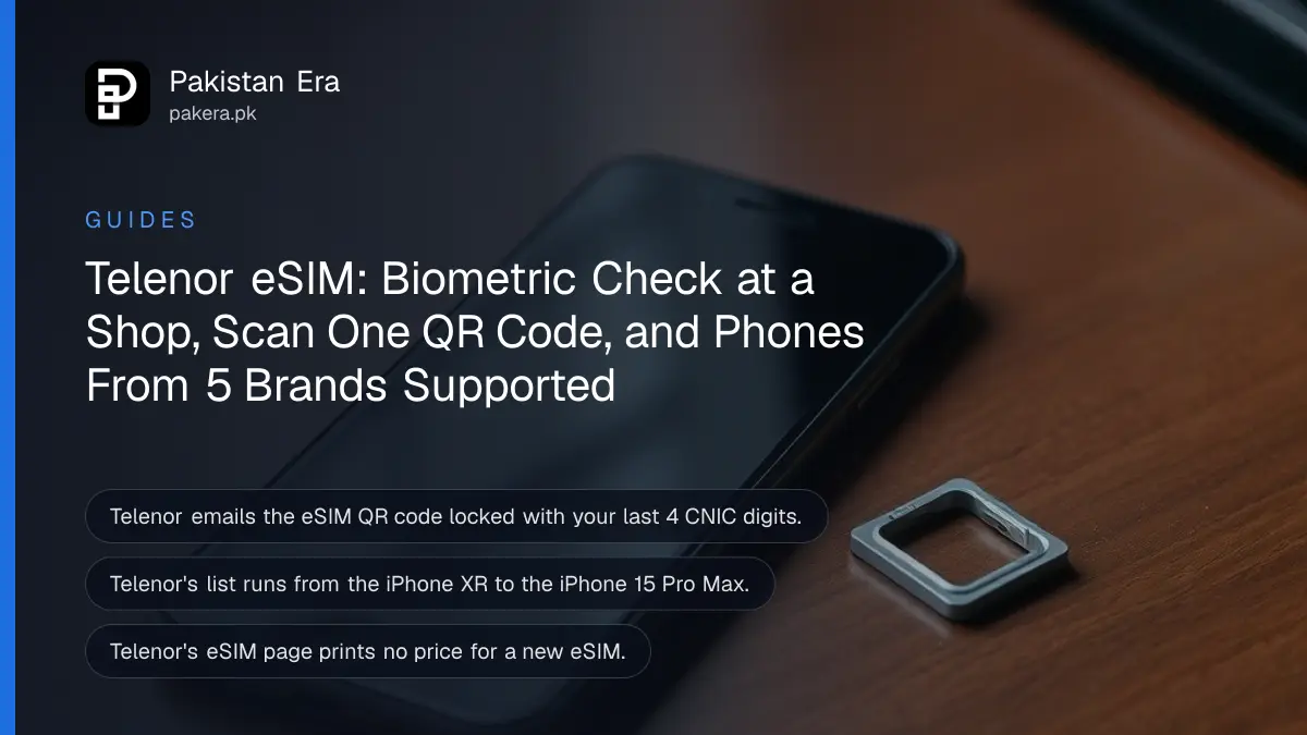 A smartphone lying face up on a wooden desk with its screen dark beside a small SIM ejector pin and an empty SIM tray