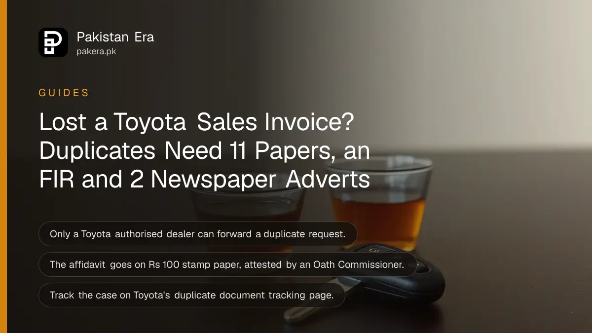A car key resting on a dark wooden table beside a cup of tea in soft daylight