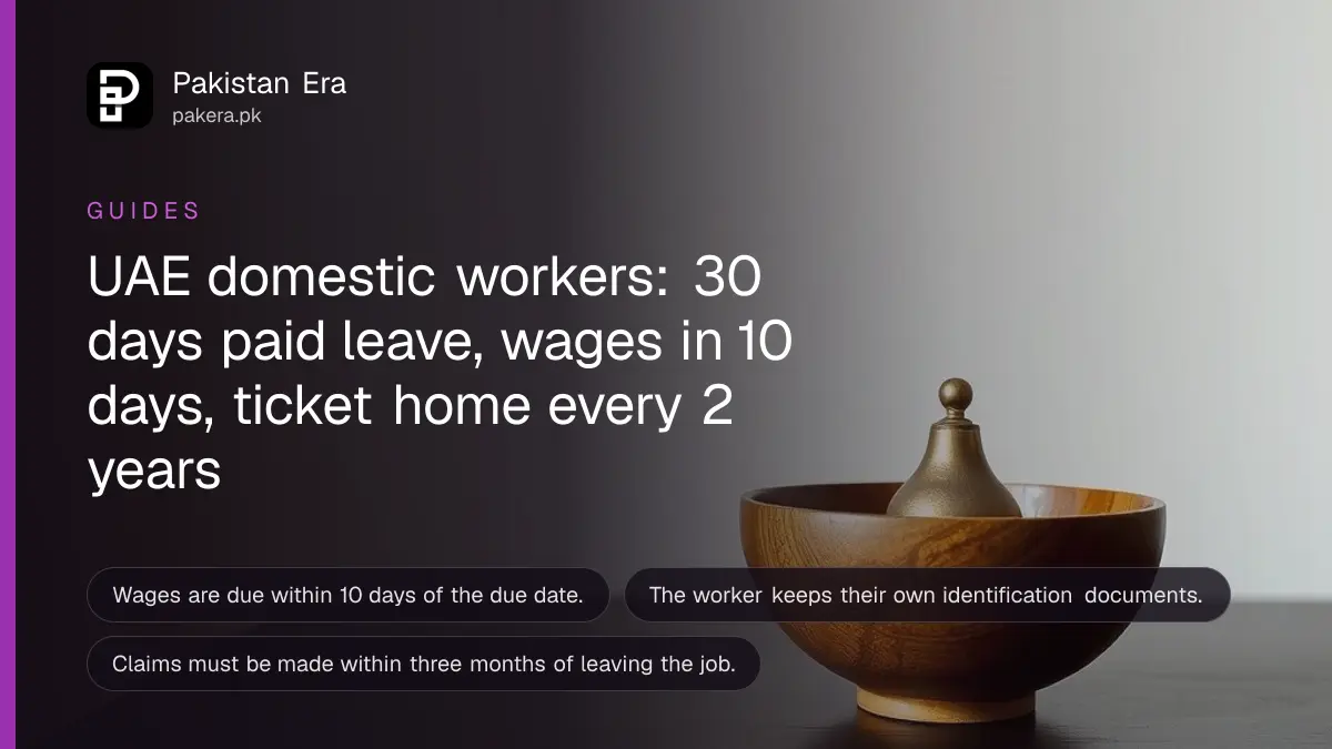 A wooden bowl and a small brass bell on a dark wooden table, for an article on uae domestic worker rights