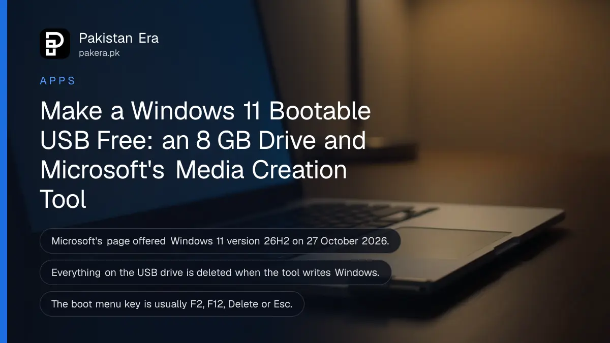 An open plain silver laptop seen from the side on a wooden desk, screen softly glowing, with a small USB flash drive beside it
