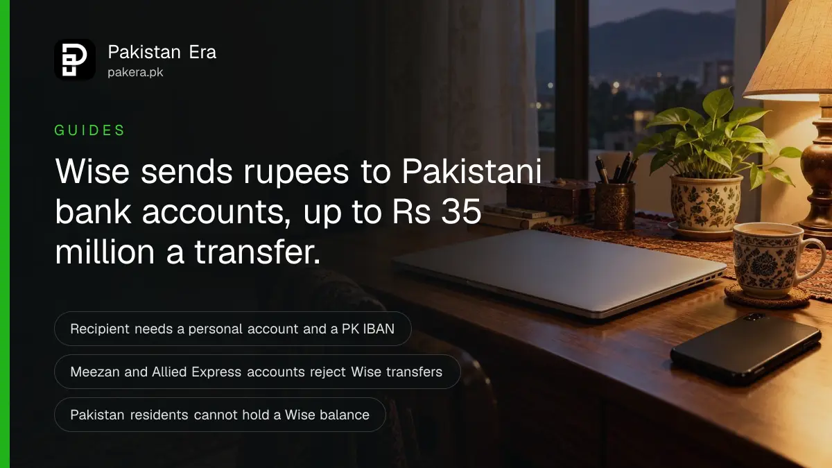 A closed laptop, a phone face down and a cup of tea on a desk at home in Islamabad in the evening