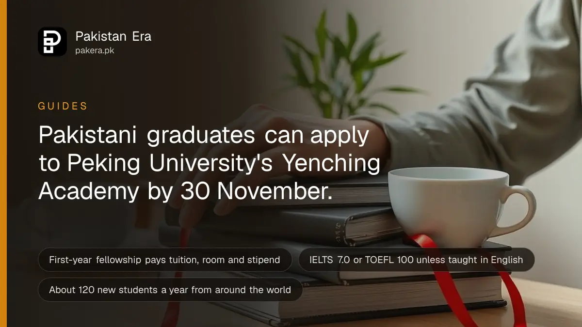Hands resting on closed hardback books beside a small potted bamboo plant and a white porcelain tea cup on a study desk