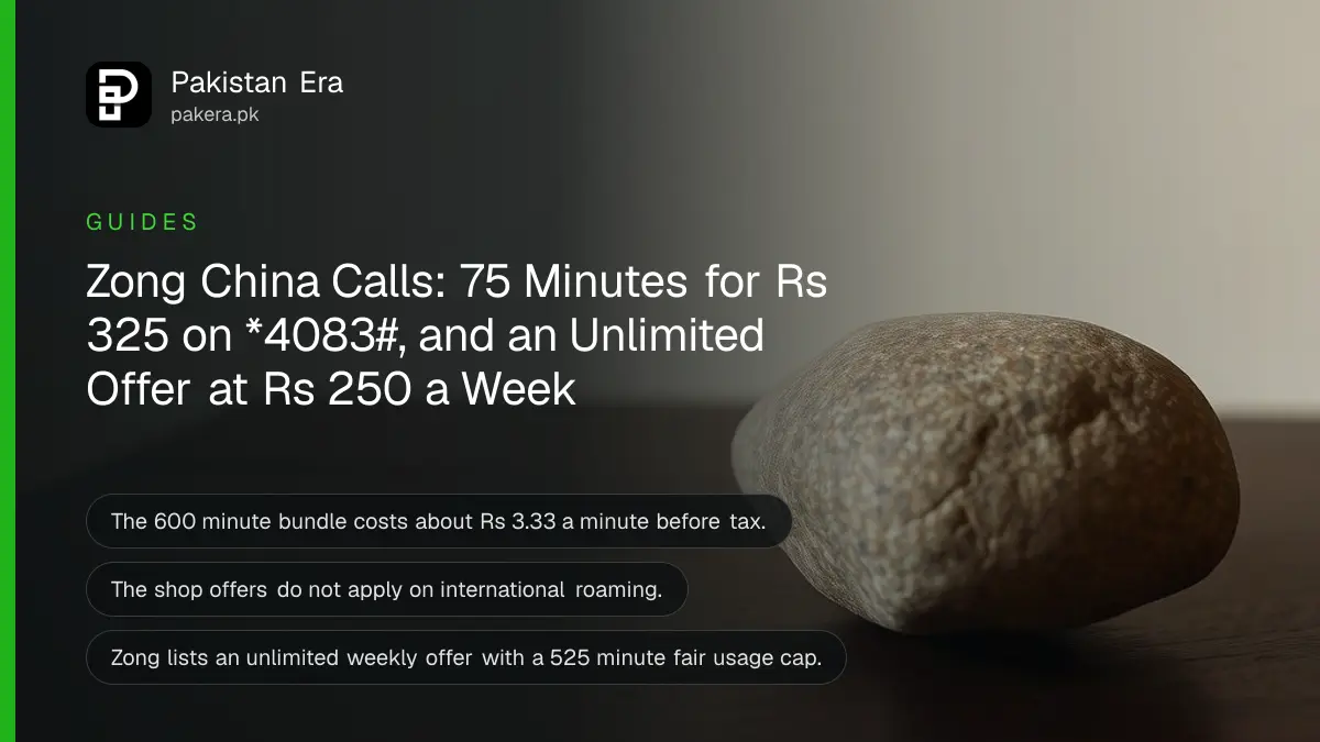 A smooth stone resting on a dark wooden table against a plain cream wall in soft daylight